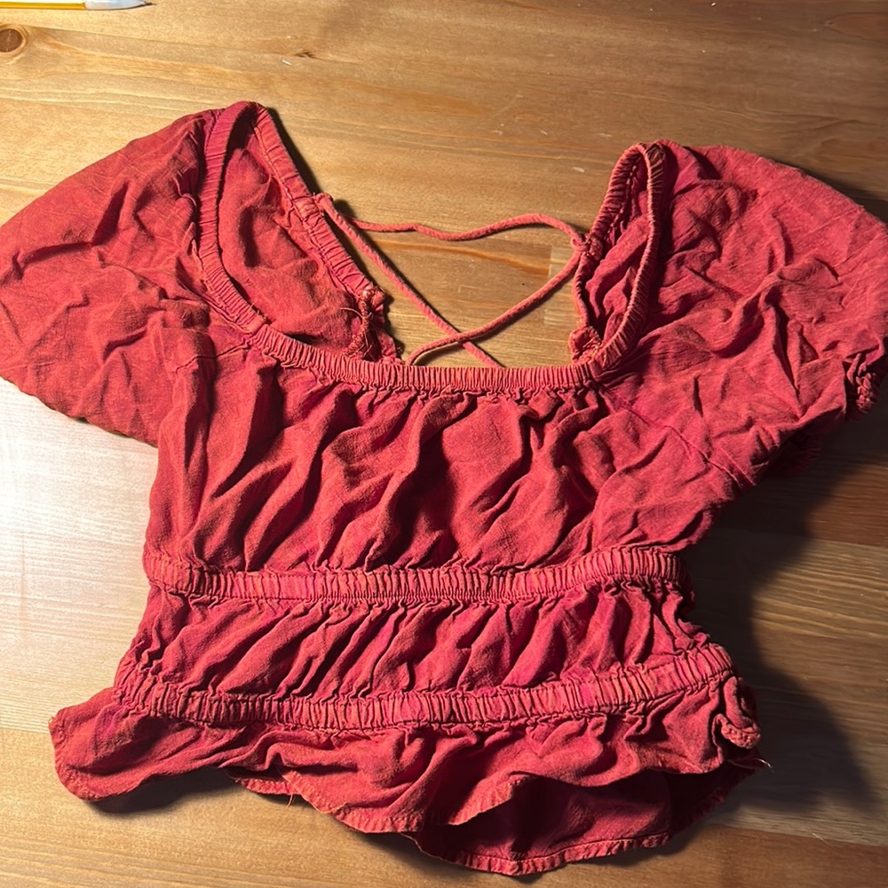 dark red cut out top with puff sleeves.